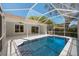 Inviting screened-in pool area with a sparkling blue pool and ample space for outdoor entertaining at 970 Ridgewood Ter, Tarpon Springs, FL 34689