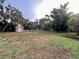 Large backyard featuring a brick outbuilding and a white picket fence, offering privacy and potential at 1002 W Pinedale Dr, Plant City, FL 33563