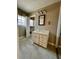 Bathroom featuring a single sink vanity, mirrored medicine cabinet, and shuttered window at 1002 W Pinedale Dr, Plant City, FL 33563