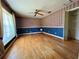 Bedroom showcasing hardwood floors, a fan, and an attached closet, with custom wallpaper at 1002 W Pinedale Dr, Plant City, FL 33563