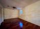 Bedroom featuring hardwood floors, a ceiling fan, and a window with natural light at 1002 W Pinedale Dr, Plant City, FL 33563