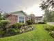 Beautiful brick home with manicured landscaping and lush greenery, creating a warm and inviting curb appeal at 1002 W Pinedale Dr, Plant City, FL 33563
