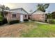 Back exterior view showing a brick building, with white trim and well-maintained landscaping at 1002 W Pinedale Dr, Plant City, FL 33563