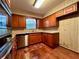 Cozy kitchen with stainless steel appliances, wooden cabinets, granite countertops, and hardwood flooring at 1002 W Pinedale Dr, Plant City, FL 33563