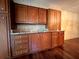 Kitchen featuring wood cabinets, granite countertops, a tile backsplash, and hardwood flooring at 1002 W Pinedale Dr, Plant City, FL 33563