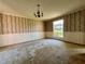 Spacious living room with vintage wallpaper and large window bringing in natural light at 1002 W Pinedale Dr, Plant City, FL 33563