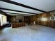 Spacious living room with a brick fireplace, built-in shelving and wood paneling at 1002 W Pinedale Dr, Plant City, FL 33563