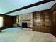 Living room featuring a brick fireplace with built-in shelving and hardwood flooring at 1002 W Pinedale Dr, Plant City, FL 33563