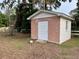 Charming brick outbuilding with a white door, adding character and functionality to the property at 1002 W Pinedale Dr, Plant City, FL 33563