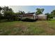 Brick home featuring lush landscaping, mature trees, and a well-maintained lawn at 1002 W Pinedale Dr, Plant City, FL 33563