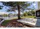 Backyard with a grassy area, patio, mature tree, and waterfront view create a tranquil outdoor setting at 10744 Drummond Rd, Tampa, FL 33615