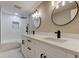 Renovated bathroom features double sink vanity, modern fixtures, and tiled shower at 10744 Drummond Rd, Tampa, FL 33615