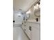 Bathroom features double sink vanity with modern fixtures and tiled shower with niche at 10744 Drummond Rd, Tampa, FL 33615