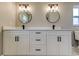 Double sink bathroom features a modern vanity, framed mirrors, and stylish fixtures for a contemporary appeal at 10744 Drummond Rd, Tampa, FL 33615