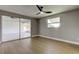 Cozy bedroom includes a fan, a window, and a sliding door to an enclosed patio, blending indoor-outdoor living at 10744 Drummond Rd, Tampa, FL 33615