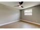 This gray bedroom has wood-look floors, ceiling fan, and one window at 10744 Drummond Rd, Tampa, FL 33615