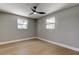 Comfortable bedroom with two windows allowing natural light and a ceiling fan providing a relaxing atmosphere at 10744 Drummond Rd, Tampa, FL 33615