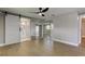 Inviting bedroom featuring modern fan, a sliding barn door to the bathroom, and mirrored closet for spaciousness at 10744 Drummond Rd, Tampa, FL 33615