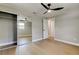 Bedroom features wood-look flooring, closet with mirrored doors, and ceiling fan at 10744 Drummond Rd, Tampa, FL 33615