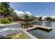 A waterfront view showcases a private dock for boat access to the adjacent canal and waterways at 10744 Drummond Rd, Tampa, FL 33615