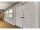 Bright front entry featuring white double doors and wood-look floors, and natural light at 10744 Drummond Rd, Tampa, FL 33615