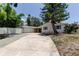 Charming single-story home with a wide driveway, lush trees, and welcoming curb appeal at 10744 Drummond Rd, Tampa, FL 33615