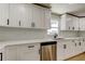 Modern kitchen featuring white cabinets, stainless steel appliances, and white subway tile backsplash at 10744 Drummond Rd, Tampa, FL 33615