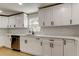 Modern kitchen featuring white cabinets, stainless steel appliances, and white subway tile backsplash at 10744 Drummond Rd, Tampa, FL 33615