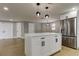 Bright kitchen featuring white cabinets, stainless steel appliances, quartz countertops and a center island at 10744 Drummond Rd, Tampa, FL 33615