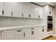 Close up of new stainless steel appliances and white cabinets in a remodeled kitchen at 10744 Drummond Rd, Tampa, FL 33615
