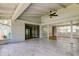 Enclosed lanai with tile floors, high ceilings, and glass sliders leading to multiple rooms at 10744 Drummond Rd, Tampa, FL 33615
