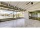 Enclosed lanai with tile floors, ceiling fan, and glass sliders leading to bathroom and views of the canal at 10744 Drummond Rd, Tampa, FL 33615