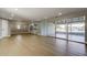 Expansive open-concept living area with sleek flooring and seamless flow to outdoor spaces at 10744 Drummond Rd, Tampa, FL 33615