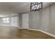 Bright living room featuring wood-look flooring, a modern chandelier, and neutral paint throughout at 10744 Drummond Rd, Tampa, FL 33615