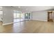 Spacious living room with modern floors and sliding glass doors to screened porch at 10744 Drummond Rd, Tampa, FL 33615