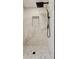 Contemporary walk-in shower showcases marble-look tiles, a sleek shower head, and a convenient built-in niche at 10744 Drummond Rd, Tampa, FL 33615