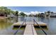 Waterfront dock overlooking tranquil canal with views of boats and neighboring houses at 10744 Drummond Rd, Tampa, FL 33615