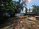 Fenced backyard with patio and grill, surrounded by mature trees at 11735 86Th Ave, Seminole, FL 33772