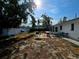 Fenced backyard with patio and grill, surrounded by mature trees at 11735 86Th Ave, Seminole, FL 33772