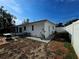 Wide shot of white home with a screened in patio in the backyard at 11735 86Th Ave, Seminole, FL 33772