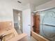 Vintage bathroom featuring a tiled sink, pink shower and glass door at 11735 86Th Ave, Seminole, FL 33772