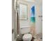 Bathroom features a low window for privacy and blue curtain at 11735 86Th Ave, Seminole, FL 33772