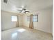 Bright bedroom features a ceiling fan, neutral walls, and neutral-colored window coverings at 11735 86Th Ave, Seminole, FL 33772