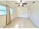 Bright bedroom features a ceiling fan, neutral walls, and neutral-colored window coverings at 11735 86Th Ave, Seminole, FL 33772