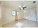Bright bedroom features a ceiling fan, neutral walls and neutral-colored window coverings at 11735 86Th Ave, Seminole, FL 33772