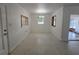 Clean dining room with terrazzo floors, decorative light fixture, and natural light from windows at 11735 86Th Ave, Seminole, FL 33772