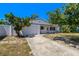 Inviting single-story home with an attached garage and manicured front yard landscaping at 11735 86Th Ave, Seminole, FL 33772