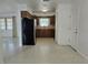 Well-lit kitchen with wooden cabinets, stainless steel refrigerator, and access to the dining area at 11735 86Th Ave, Seminole, FL 33772