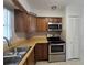 Traditional kitchen featuring wood cabinets, stainless steel appliances, and laminate countertops at 11735 86Th Ave, Seminole, FL 33772