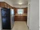 Functional kitchen featuring wood cabinets, a stainless steel refrigerator, and natural light at 11735 86Th Ave, Seminole, FL 33772